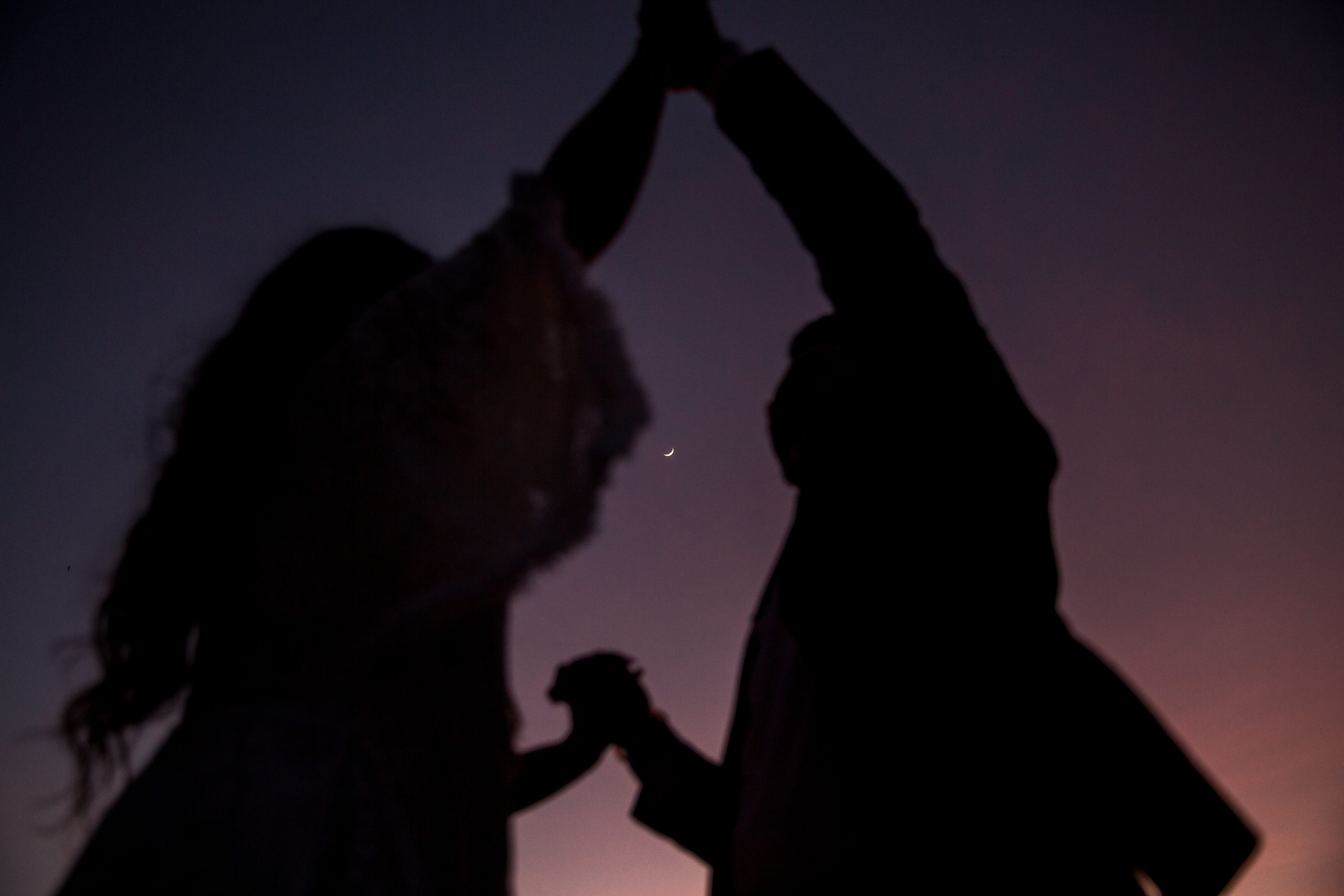 rebecca skidgel photography arizona elopemennt photographer boho desert sunset moon couple holding hands