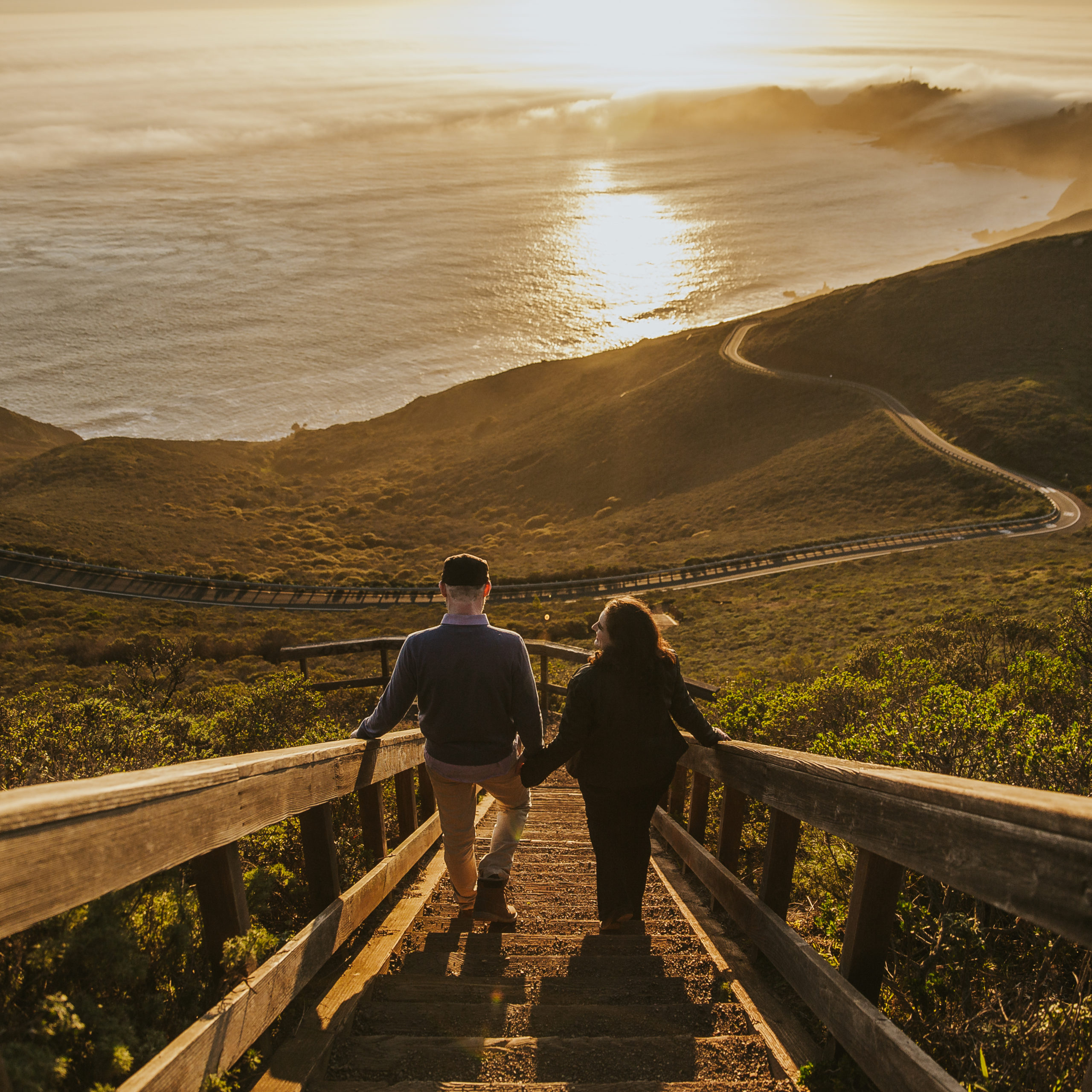 rebecca skidgel photography bay area california photographer golden hour engagement couple holding hands walking down staircase