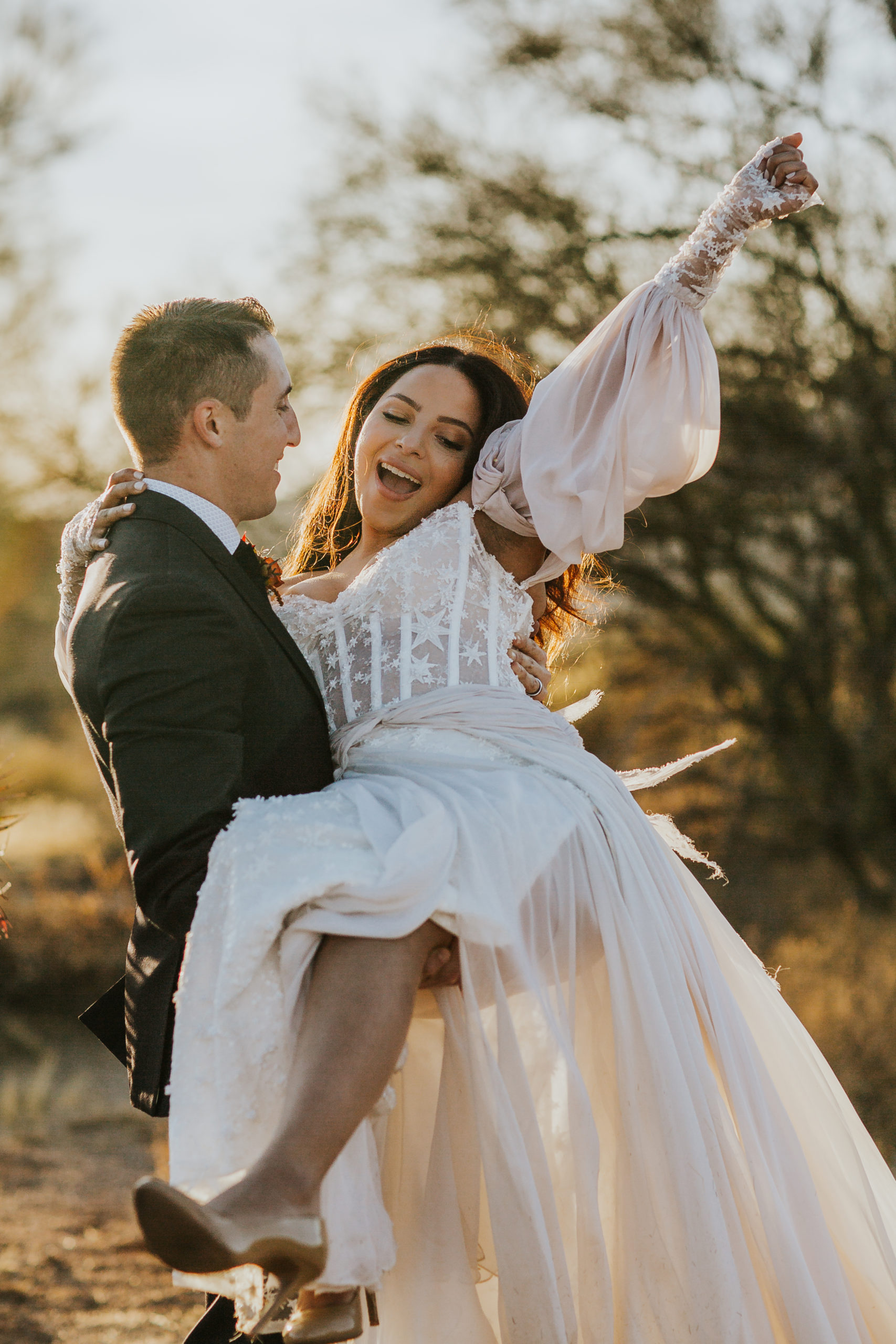 rebecca skidgel photography arizona wedding elopement photographer mesa bride and groom holding each other smiling boho desert
