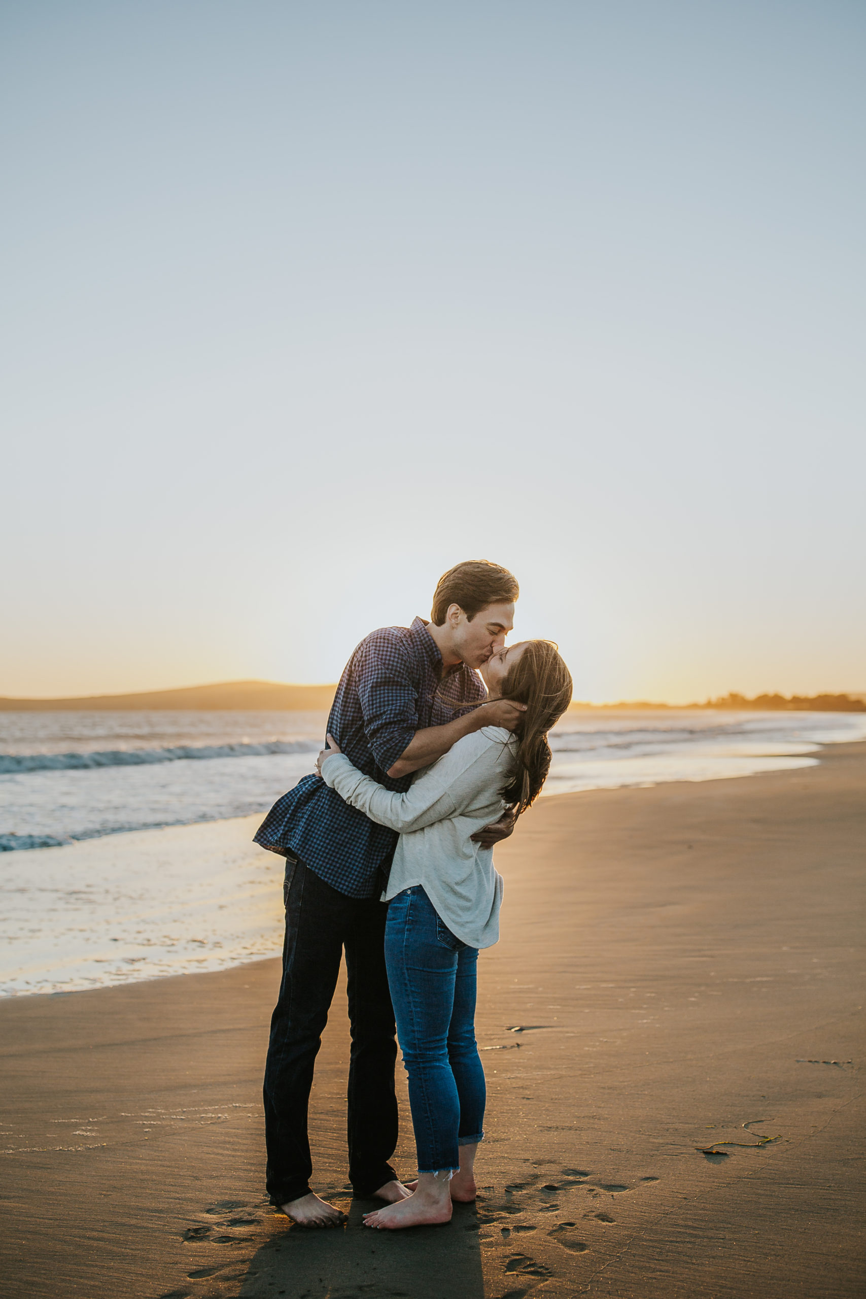 rebecca skidgel photography coastal engagement photographer bodega bay couple holding each other kissing