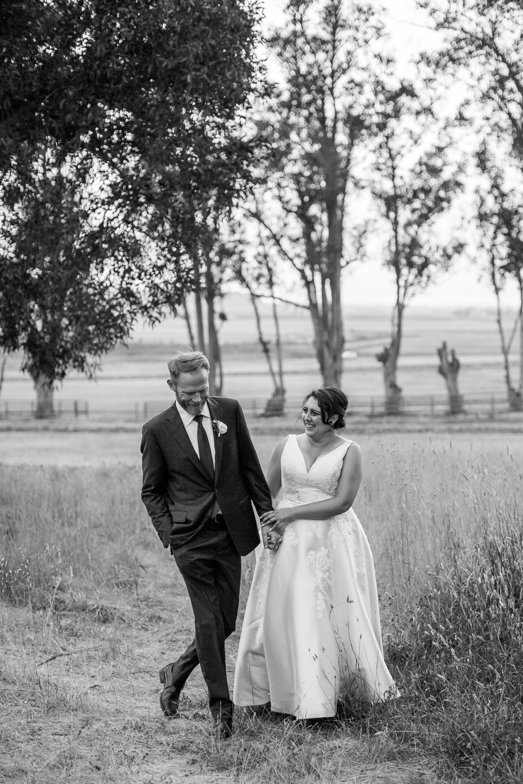 rebecca skidgel photography petaluma wedding photographer private estate bride groom walking laughing