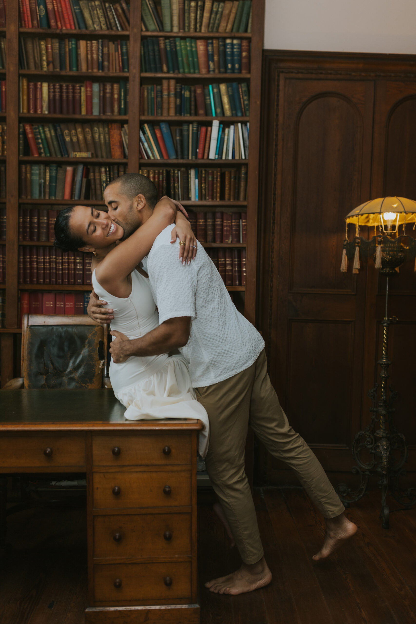 playful couple in the library cozying up