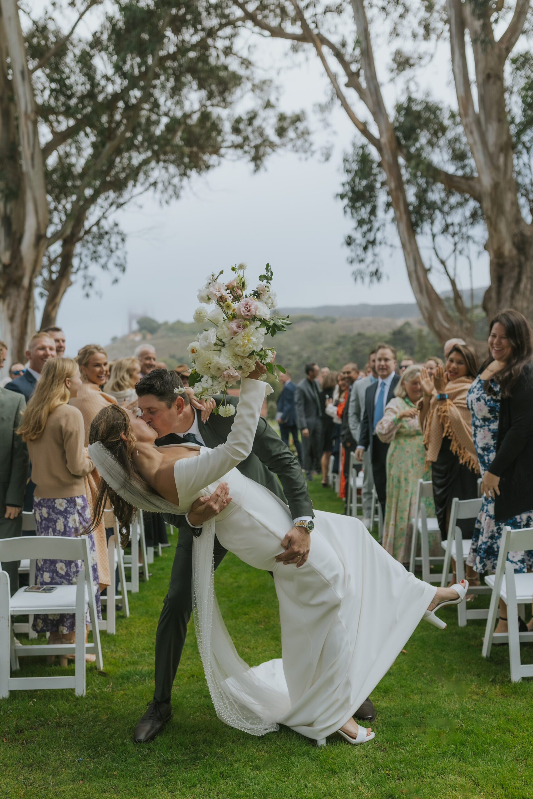 Bride and groom dip kiss at the end of the wedding ceremony at Cavallo Point Lodge in Sausalito